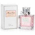 Miss Dior perfume bottle and packaging on a wooden surface