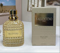 Valentino perfume bottle and packaging on a table with a neutral background